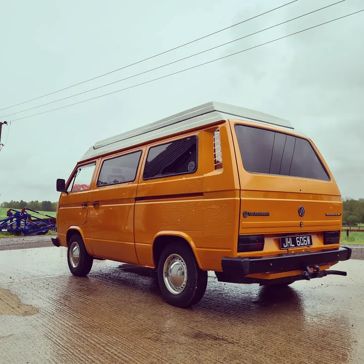 Volkswagen T25 camper photographed from the rear quarter on the workshop forecourt.