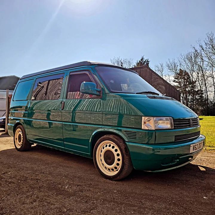 Volkswagen T4 Transporter photographed from the front quarter with reflections along the side and bonnet.