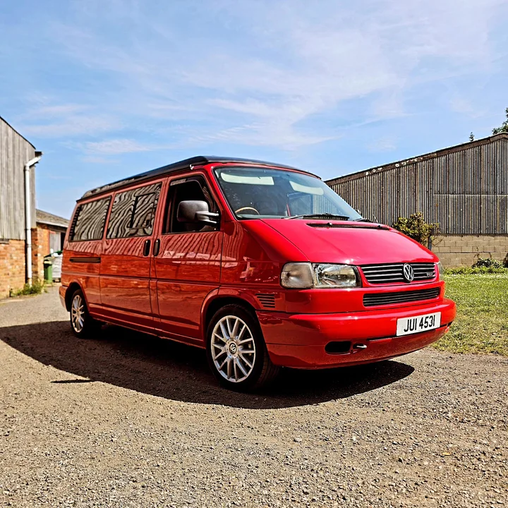 Volkswagen T4 camper photographed from the opposite front quarter on the workshop forecourt.